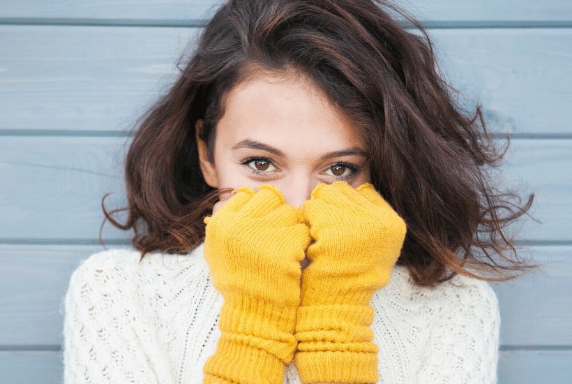 an image of a woman wearing a white sweater with yellow gloves while she's grasping her face with her hands featured for God Given Opportunities Are Powerful Ways For A Heart Change