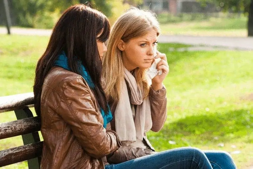 an image of two women sitting on a park bench featured image for 7 Helpful Ways to Find Healing from Abuse