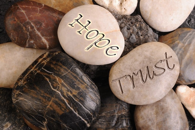 an image of rocks that have hope, trust, and faith written on them