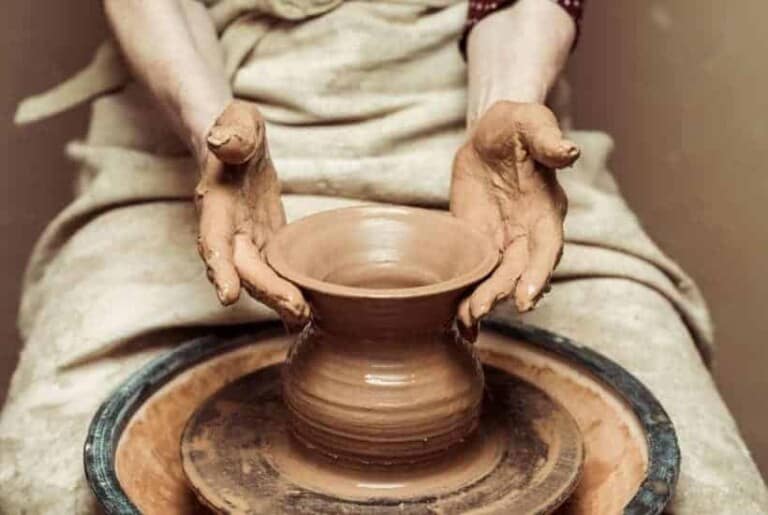 a woman molding clay on a pottery wheel featured image for Spiritual Growth: Molded by the Hands of the Potter