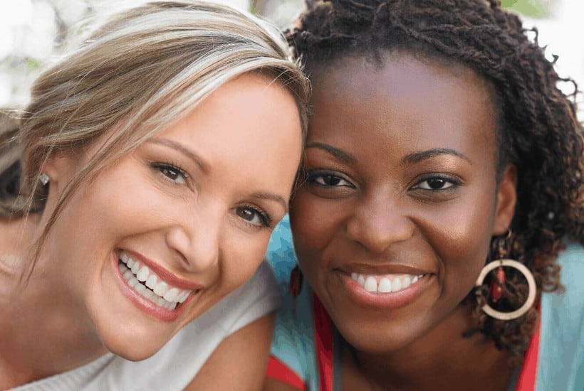an image of a black and white woman friends smiling featured image for Unity in Diversity 7 Ways to Diffuse Your Anger