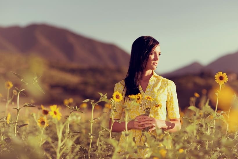 an image of a woman in a field of yellow flowers wearing a yellow dress featured image for What Does the Bible Say about Hope for the Future?
