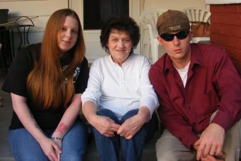 a group of people sitting on a porch